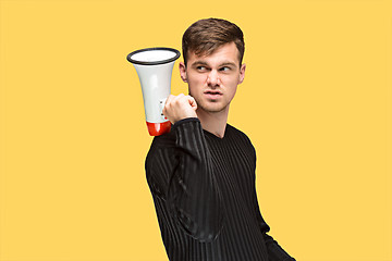 Image showing The young man holding a megaphone