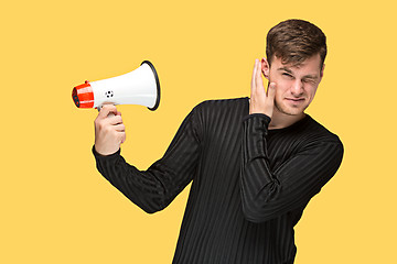 Image showing The young man holding a megaphone