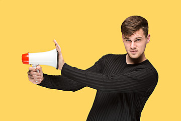 Image showing The young man holding a megaphone