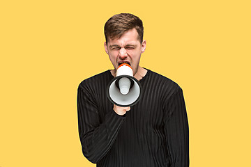 Image showing The young man holding a megaphone
