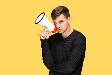 Image showing The young man holding a megaphone