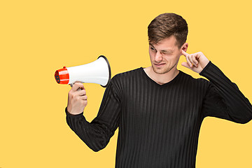 Image showing The young man holding a megaphone