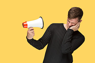 Image showing The young man holding a megaphone