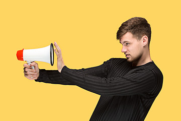 Image showing The young man holding a megaphone