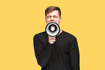 Image showing The young man holding a megaphone