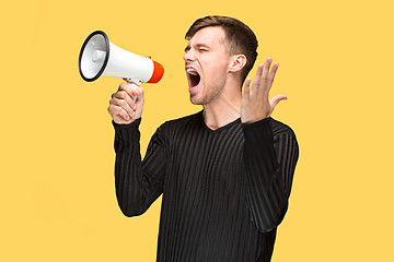 Image showing The young man holding a megaphone