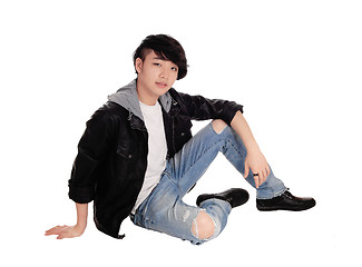 Image showing Young Asian man sitting on floor.