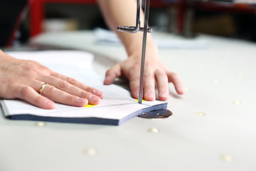 Image showing Cutting room, cutting cloth tailoring knife. 