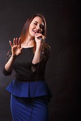 Image showing Singer in dress with microphone