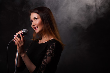 Image showing Singing brunette background of smoke