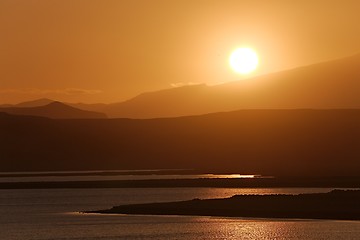 Image showing Sunset with Lake and Hilly Landscape