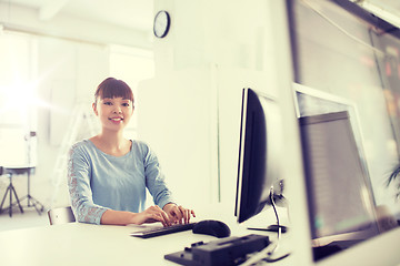 Image showing happy asian woman with computer at office