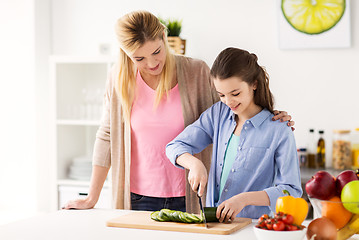 Image showing happy family cooking dinner at home kitchen