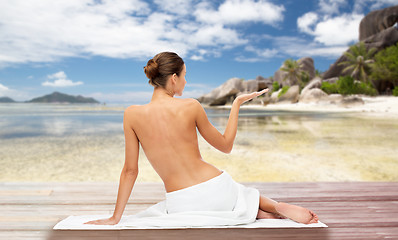 Image showing beautiful woman in towel with bare top on beach