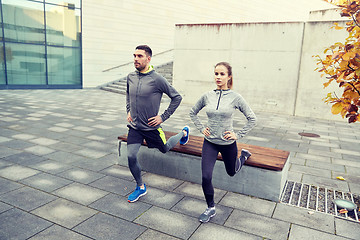 Image showing couple doing lunge exercise on city street