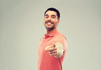 Image showing man pointing finger to you over gray background