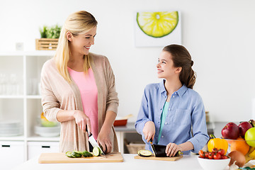 Image showing happy family cooking dinner at home kitchen