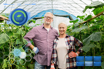 Image showing happy senior couple at farm greenhouse