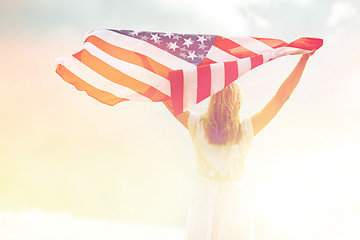 Image showing happy young woman with american flag outdoors