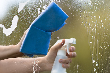 Image showing hands washing window of car