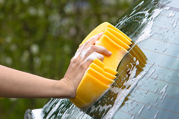 Image showing hand washing the rear screen of a car