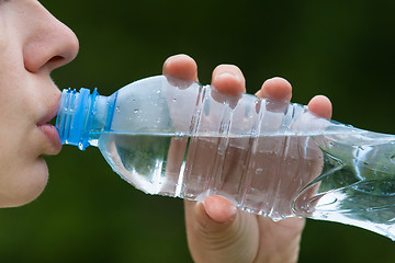 Image showing woman drinking water from a bottle