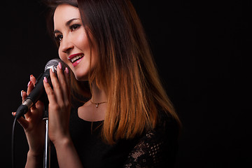 Image showing Girl with microphone in hands