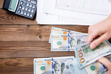 Image showing Hands hold and counting us dollar banknotes