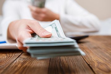 Image showing Hands of person proposing money to you - closeup shot