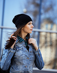 Image showing young pretty girl near business building walking