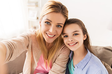 Image showing happy family taking selfie at home