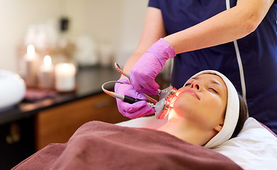 Image showing young woman having face microdermabrasion at spa