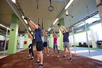 Image showing group of people with kettlebells exercising in gym