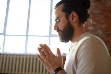 Image showing close up of man meditating at yoga studio