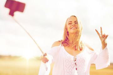 Image showing happy young woman taking selfie by smartphone