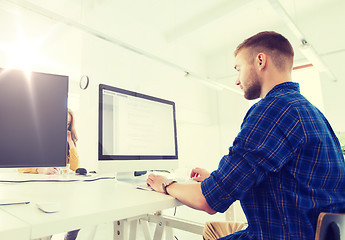 Image showing creative man or programmer with computer at office