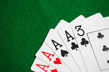 Image showing poker hand of playing cards on green casino cloth