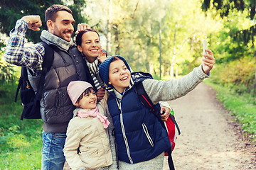 Image showing family with backpacks taking selfie by smartphone