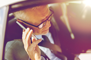 Image showing senior businessman calling on smartphone in car