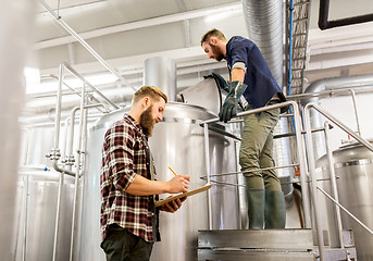 Image showing men with clipboard at craft brewery or beer plant