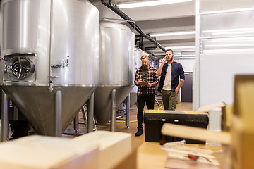 Image showing men working at craft brewery or beer plant