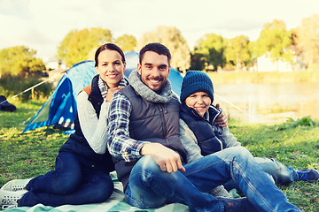 Image showing happy family with tent at camp site