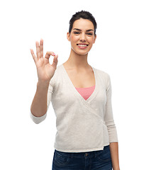 Image showing happy smiling woman with braces showing ok