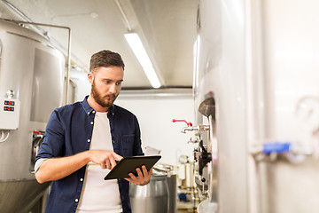 Image showing man with tablet pc at craft brewery or beer plant