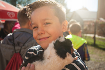 Image showing happy smiling boy with cavy