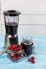 Image showing Cherry juice with glass of berries