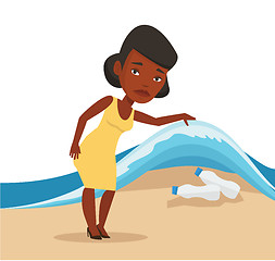 Image showing Woman showing plastic bottles under sea wave.