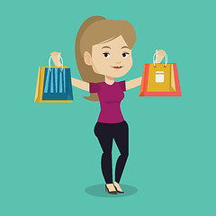 Image showing Happy woman holding shopping bags.