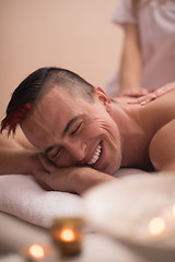 Image showing young man having a back massage