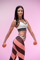 Image showing The woman training against pink studio